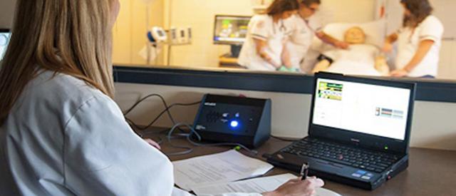 Nurse watching others in lab